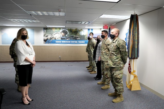 Secretary of the Army Hon. Christine Wormuth prepares to present challenge coins to a group of Fort Leavenworth Soldiers and one civilian in recognition of excellence during her visit to the Combined Arms Center-Training Innovation Facility at Fort Leavenworth, Kan. March 21, 2022. Included in the group were Sgt. Maj. Greg Brobst from CAC-Headquarters, Dr. Marilyn Willis-Grider from Mission Command Center of Excellence, Lt. Col. Eric Glassman from Mission Command Training Program and Lt. Col. Kyle Yanowski from Combined Arms Center-Training. Curt Pangracs from Army University was unable to attend and his coin was accepted by his supervisor. Photo by Tisha Swart-Entwistle, Combined Arms Center-Public Affairs.