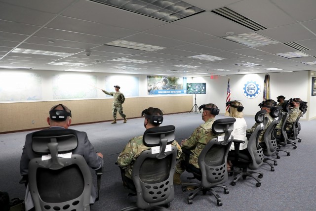 Col. Kevin McHugh from the Fielded Force Integration Directorate prepares to brief Secretary of the Army Hon. Christine Wormuth via mixed reality headsets at the Combined Arms Center-Training Innovation Facility during a visit to Fort Leavenworth March 21, 2022. The group also included FFID Director Dr. Paul Reese, Army Deputy Chief of Staff G8 Lt. Gen. Erik Peterson, Combined Arms Center Commanding General Lt. Gen. Theodore Martin, Training and Doctrine Command Commanding General Gen. Paul E. Funk II and Combined Arms Center-Training Deputy Commanding General Brig. Gen. Charles Lombardo. Photo by Tisha Swart-Entwistle, Combined Arms Center-Training Public Affairs.