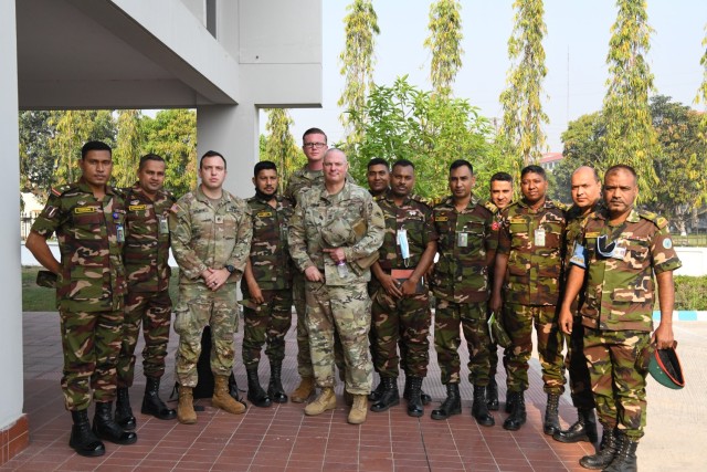 U.S. Army delegates pause for a photograph with Bangladeshi Army members after the opening ceremony of the Exercise Tiger Lightning 2022 March 20, 2022, at the Bangladesh Institute of Peace Support Operation Training center in Dhaka, Bangladesh. The exercise reinforced the partnership between the Oregon National Guard and the Bangladesh Armed Forces under the State Partnership Program. (Air National Guard photo by Master Sgt. Aaron Perkins, Oregon Military Department Public Affairs)