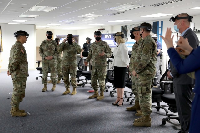 TRADOC Proponent Office-Synthetic Training Environment Director COL James Pangelinan prepares Secretary of the Army Hon. Christine Wormuth for a demonstration of the mixed reality headsets at the Combined Arms Center-Training Innovation Facility during a visit to Fort Leavenworth March 21, 2022. Photo by Tisha Swart-Entwistle, Combined Arms Center-Training Public Affairs.