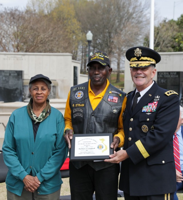 Retired Sgt. Glen Strain receives an award from the Vietnam Veterans of America Chapter 1067 for his loyalty and support to the chapter. The award was presented by Lt. Gen. Donnie Walker, deputy commanding general of the Army Materiel Command and Redstone Arsenal senior commander, on behalf of Chapter 1067 during the Vietnam Veterans Day Celebration at the Huntsville-Madison County, Ala., Veterans Memorial March 29. 