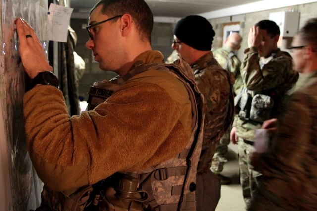 Sgt. Thomas Guttenberg, 31, Appleton, Wisconsin, a signal NCO, plots coordinates on a wall map in a crowded command post during Allied Spirit 22 in the Joint Multinational Readiness Center training area near Hohenfels, Germany. Civil Affairs Soldiers from the U.S. Army Reserve’s 432nd Civil Affairs Battalion, 353rd Civil Affairs Command, supported the multinational exercise from Jan. 21 through Feb. 5, 2022. A Green Bay, Wisconsin-based U.S. Army Reserve unit, the 432nd Civil Affairs Battalion took part in the winter exercise alongside with allied militaries. Led by the German Army&#39;s 1st Armoured Division the exercise, directed by U.S. Army Europe and Africa and conducted by the 7th Army Training Command, enabled integration between allies and partners in a competitive combat training environment.