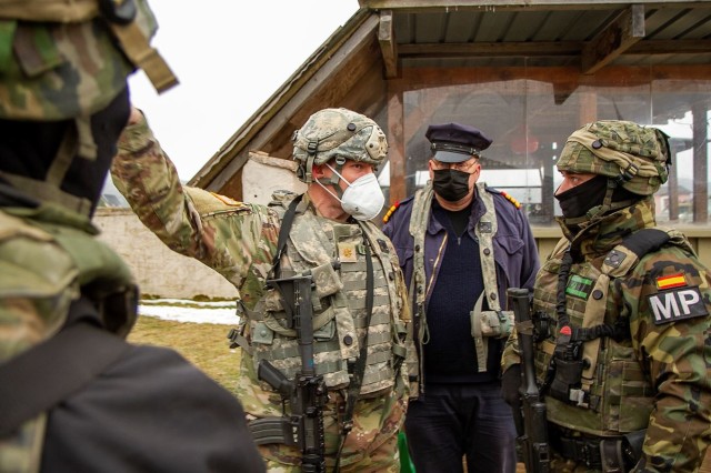 Maj. Jim O’Keefe, 43, a U.S. Army Reserve officer from Dumfries, Va., speaks with the local chief of police and a Spanish military police soldier at Kittensee during Allied Spirit 22 in the Joint Multinational Readiness Center training area near...