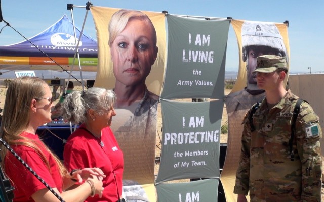 Members of the Fort Huachuca Arizona community mingle on Chaffee Parade Fiend during a Sexual Assault Awareness and Prevention Month (SAAPM) Fair.