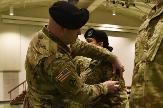 Maj. Jesse DeBoest, 58th Transportation Battalion executive officer, affixes the U.S. Army Combined Arms Support Command unit patch to the uniform of Staff Sgt. Cristal Colon, the battalion’s supply NCO, during a patching ceremony Friday at Nutter Field House. The battalion moves from the 2nd Transportation Brigade, 94th Training Division – a Reserve unit – where they were part of the Army’s Associated Units Program, to CASCOM. Headquartered at Fort Lee, Virginia, CASCOM is a parent organization of the U.S. Army Transportation School. 