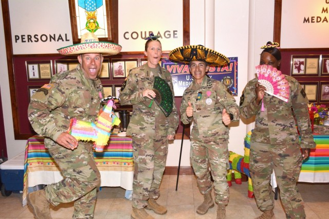 32d Medical Brigade leaders get in the Fiesta Spirit during the 2022 “Viva Fiesta” Leader Breakfast, hosted in honor of the 2022 Fiesta Court and Fiesta Commission at Fort Sam Houston, Joint Base San Antonio, March 30, 2022. Pictured left to right, Col. Marc Welde, Command Sgt. Maj. Lori Ingram, Lt. Col. Manuel Menendez, and Command Sgt. Maj. Deanna Carson.  