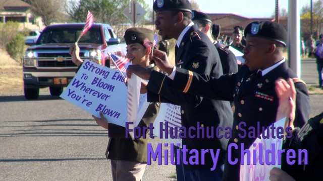 Soldiers mark the Month of the Military Child with a salute to students as they arrive at Col. Johnston Elementary School.