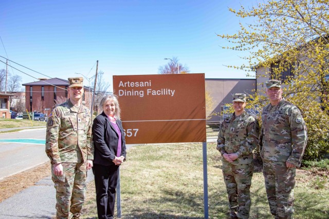 LTC Colestock, Mrs. Eileen Sullivan niece of MSG Artesani, CSM Rogers and CSM of the Army CSM Lombardo pose for a photo in front of the Artesani sign.