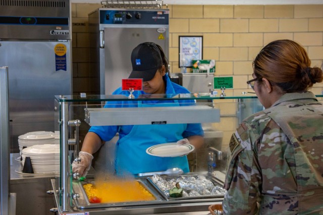 Warrior Restaurant personnel serving a Soldier lunch. 