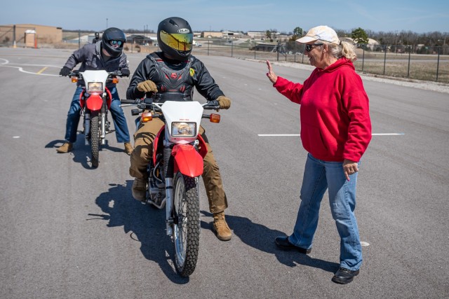 Tami Grider instructs motorcycle students in the proper techniques for stopping in a curve during the second day of the two-day Basic Rider Course Friday at Training Area 209A. 