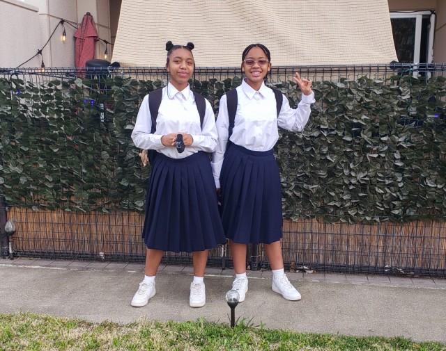Naomi and Abigail Ray, who both attend Sagamidai Junior High, pose for a photo outside their home in Sagamihara Family Housing Area, Japan. The Ray family has three children who go to Japanese schools as a way to immerse themselves in the local culture.