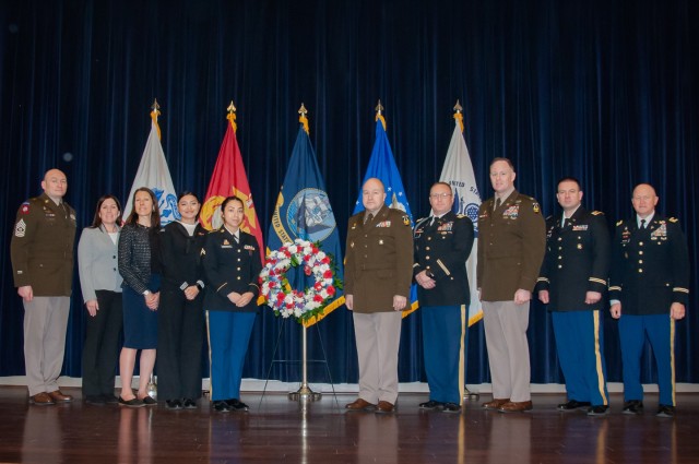 Natick Soldier Systems Center Senior Commander, Brig. Gen. David Trybula, stands with leaders and military members around the ceremonial wreath after the Medal of Honor Ceremony held in Hunter Auditorium, Mar 25. 