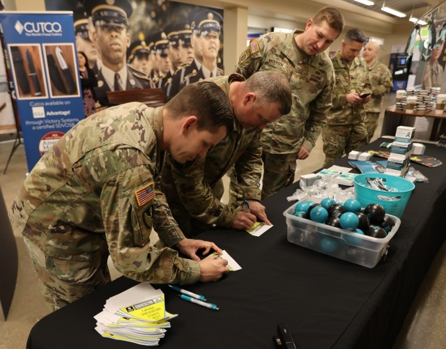 A group of Fort Knox Soldiers sign pledge pennants at the Main Exchange April 6, 2022 as part of the ‘I pledge campaign’ for Sexual Assault Awareness and Prevention Month.