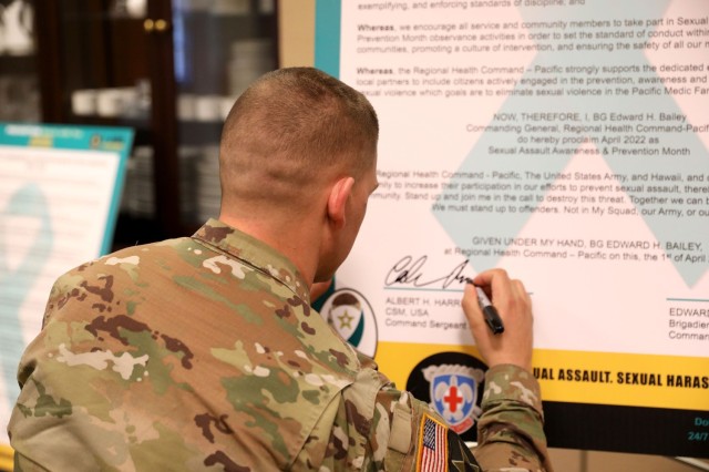 Sgt. Maj. Ryan Cole, acting command sergeant major of Regional Health Command-Pacific, signs a proclamation April 5 recognizing Sexual Assault Awareness and Prevention Month in the command. Cole encouraged people to intervene if they witness sexual assault or sexual harassment. “Be a proactive bystander. Take action if you notice someone needs help,” Cole said.