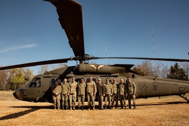 Members of the Oklahoma Army National Guard, 137th Special Operations Wing and doctors with the Azerbaijan Operational Capabilities Concept Battalion pose for a group photo in front of an UH-60 Black Hawk helicopter during a medical knowledge exchange in Oklahoma City, April 1, 2022. The knowledge exchange involved the participation and support of Guardsmen with both the Oklahoma Army and Air National Guard in support of the State Partnership Program. (U.S. Air National Guard photo by Tech. Sgt. Brigette Waltermire)