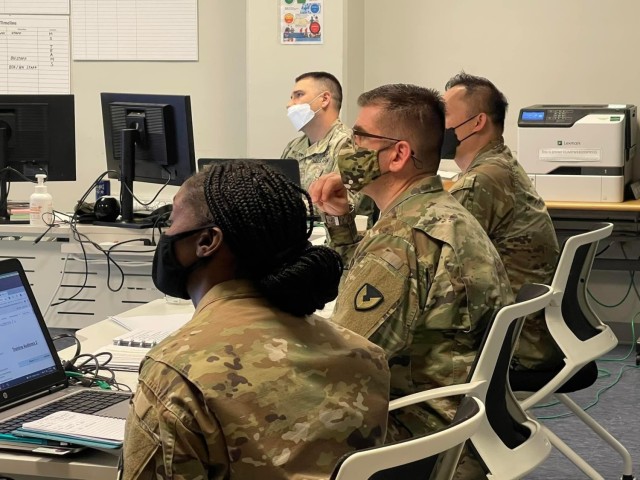 ACC&#39;s deputy commanding general for overseas operations, Col. Robert J. Miceli, receives a command update briefing during the EXEVAL from the leadership of the 906th Contracting Battalion.