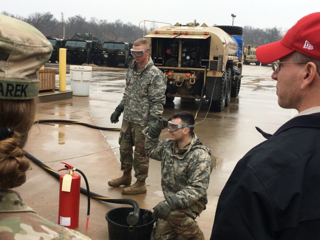 WIARNG eMS Team Environmental Branch Chief Scott Rickard (right) collaborates with Units from the 32nd IBCT and 157th MEB to offer Mobile Fueler Spill prevention and response training during annual training at MATES at Fort McCoy. Here they are executing a fuel drop into an underground storage tank.