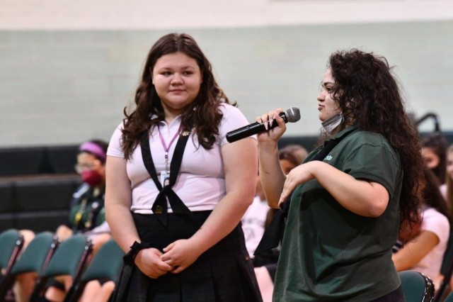 Incarnate Word High School student asks panelists questions as another student moderates the IWHS Science, Technology, Religion, Engineering, Arts & Math (STREAM) speaker panel at IWHS, San Antonio, Texas, April 5, 2022. U.S. Army Medical Center of Excellence’s Col. Shannon Shaw, Director of the Leader Training Division and Maj. Lakeisha Logan, Deputy Command Surgeon participated in the panel for junior and seniors. Chaplain (Lt. Col.) Valeria Van Dress, the MEDCoE Command Chaplain participated in the freshman and sophomore panel.  Other guest speakers included Kaitlin Teniente, Director of Esports, St. Mary’s University, Jodie Jasper, Investigator, U.S. Department of Agriculture, and Laurie Richardson, Veterinarian, Oaks North Animal Hospital. 