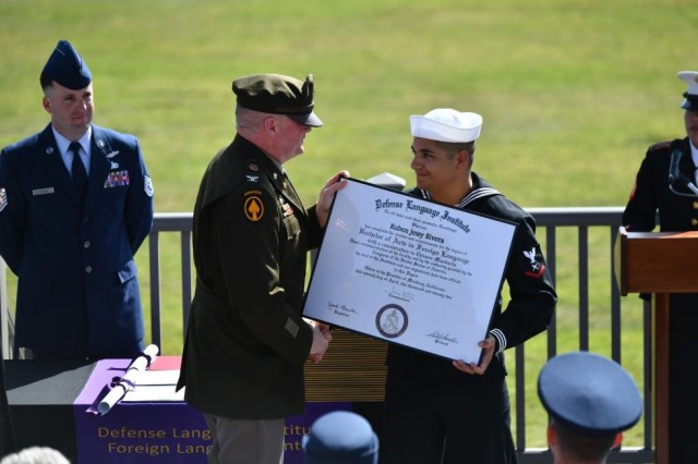 Cryptologic Technician (Interpretive) 3rd Class Ruben Rivera receives his BA degree diploma from DLIFLC Commandant, Colonel James A. Kievit.