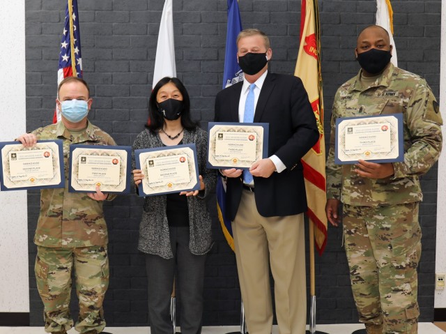 Noriko Kudo, second from left, poses for a photo with her certificates during an awards presentation at Camp Zama, Japan, April 14, 2022. Col. Christopher L. Tomlinson, left, commander of U.S. Army Garrison Japan; Craig L. Deatrick, director of U.S. Army Installation Management Command-Pacific; and Command Sgt. Maj. Jason R. Copeland, senior enlisted leader of IMCOM-Pacific, presented certificates to nine local employees who placed in the first-ever Jim “Goose” Guzior Communications Awards. 