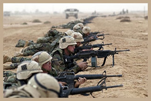 Soldiers from the Sledgehammer Brigade fighting alongside soldiers from the 1st Brigade, 3ID during the invasion of Iraq.  Sledgehammer Soldiers wore the green patch on their helmets, while the other brigades wore a desert brown patch