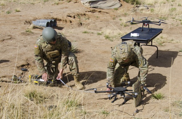 A pair of EOD Soldiers set up a portable x-ray system to scan a training aid representing a captured drone. Off the shelf drones rigged to deliever explosives are a technology seen more and more on modern battlefields.