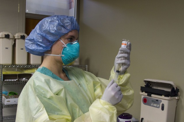 DENVER, Colo. — U.S. Air Force 2nd Lt. Esther Harbach, registered nurse with 60th Medical Group, prepares to administer an intravenous infusion of monoclonal antibodies to a patient for treatment of COVID-19 at the Frederico F. Pena Southwest...