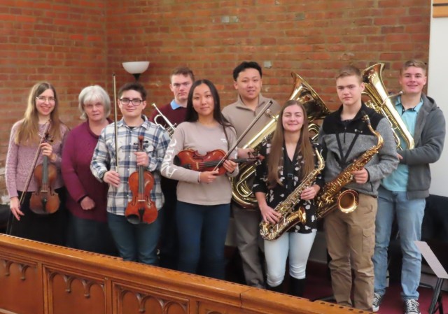 Fort Knox Main Post Chapel orchestra leader Janell Deckard (far left) poses with the pianist and seven teen members of the orchestra who performed the Hallelujah Chorus at Easter Sunday service April 17, 2022.