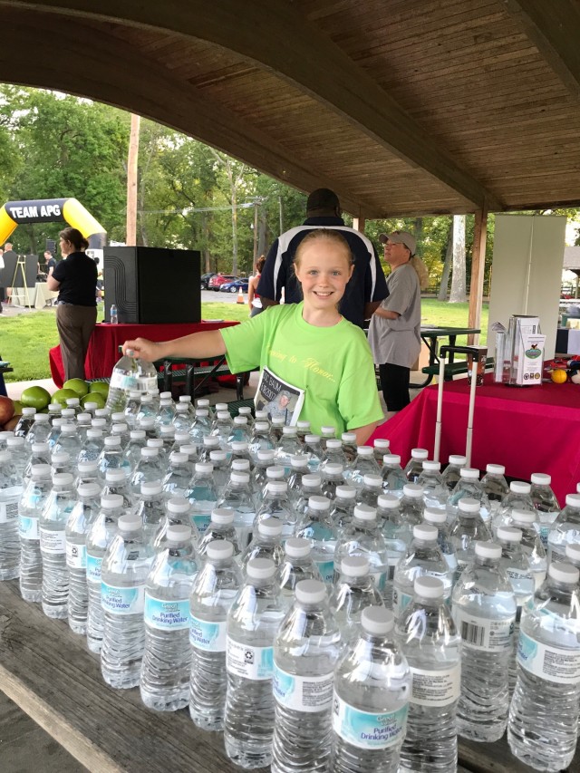 Leia Ryan Baum started volunteering when she was five years old including planting trees and cleaning trash during area beautification events, collecting time cards at Maryland Special Olympic events, as well as other efforts during the past ten years. Here, she hands out water bottles at Aberdeen Proving Ground’s Run to Remember 5K, Maryland.