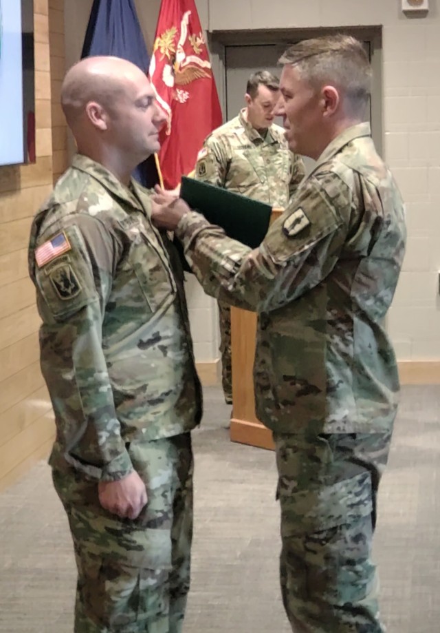 U.S. Staff Sgt. Andrew Fryburg, chief instructor at the 24th Regimental Training Institute’s modular training battalion, was presented with the master instructor badge April 19, 2022, by Col. William Wagner, RTI commanding officer.  Fryburg is the first Vermont National Guard RTI instructor to have attained the master instructor badge, which requires 500 hours of study. (U.S. Army National Guard photo by Joshua T. Cohen)