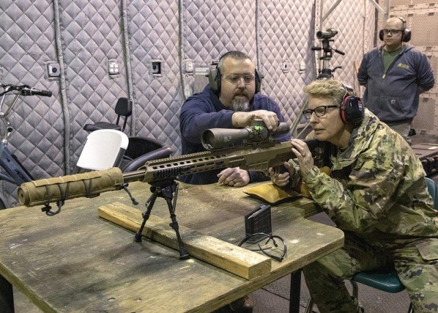 U.S. Army Contracting Command (ACC), Commanding General, Brig. Gen. Christine Beeler receives instruction on the precision sniper rifle while visiting Picatinny Arsenal, April 12.