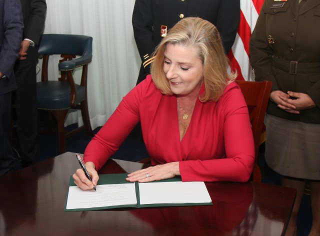 Secretary of the Army Christine E. Wormuth signs the new Army Parenthood, Pregnancy and Postpartum Directive on April 19, 2022. The directive will help new Army moms transition back to duty and also assist all Soldier parents in caring for military children.