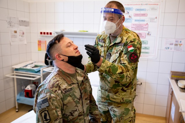 A Paratrooper assigned to the 173rd Airborne Brigade receives a PCR COVID-19 surveillance test from Hungarian Defence Force Medical Center personnel during Swift Response 21 at Papa Airbase, Hungary. The COVID testing from our Hungarian allies increases the speed in which U.S. forces see results improving the brigade's ability to move on to the next objective safely and healthy.

Swift Response 21 will occur May 6-11, as the airborne operation portion of DEFENDER-Europe 21. It will validate U.S. European Command's ability to send high readiness forces into a designated area by conducting an airborne exercise consisting of strategic jumps as part of a Joint Forcible Entry (JFE) in three countries to seize key terrain.

(U.S. Army photo by Staff Sgt. Jacob Sawyer)