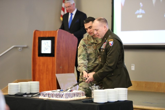 (From left to right) Staff Sgt. Mark Barnes and Army Materiel Command Chief of Staff Walt Duzzny cut a birthday cake using a ceremonial sword during a celebration of the Army Reserve&#39;s 114th birthday. (U.S. Army photo by Samantha Tyler)