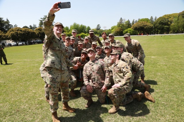 Maj. Gen. JB Vowell, commander of U.S. Army Japan, takes a selfie with Expert Soldier Badge recipients following an award ceremony at Sagami General Depot, Japan, April 22, 2022. Twenty-three Soldiers earned the coveted badge after a grueling weeklong competition, which initially had about 120 participants in USARJ’s first-ever testing event for the newest skill badge in the Army.