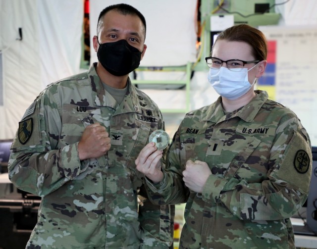 1st Lt. Kristina Bean, right, an Army nurse assigned to the 549th Hospital Center/Brian D. Allgood Army Community Hospital, Camp Humphreys, South Korea, shows off the commander&#39;s coin for excellence presented to her by Dr. (Col.) Huy Luu, 549th HC/BDAACH commander, for winning the unit&#39;s Sexual Assault Awareness and Prevention Month essay contest.