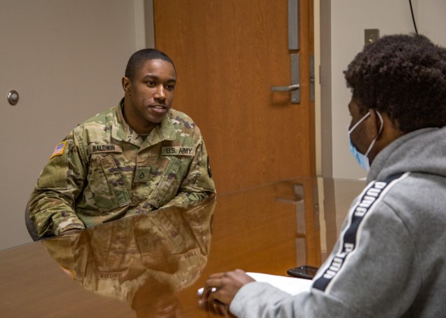 Private First Class Redell Baldwin talking to Jordan about his experience in the Army Reserve.