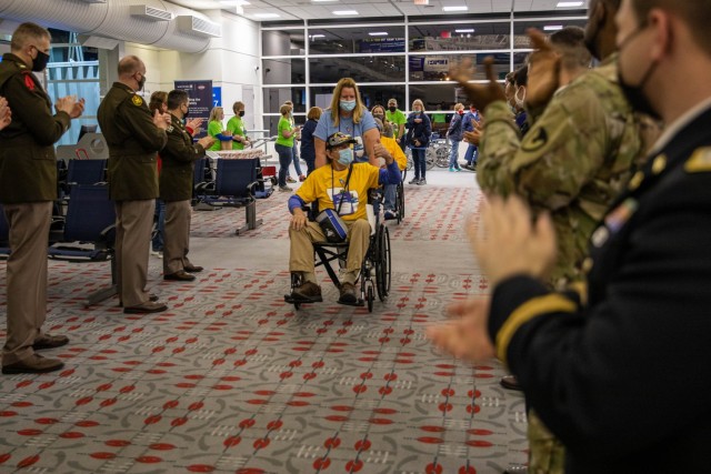 First Army Soldiers join members of other organizations to welcome home veterans returning from Washington, D.C., on a Quad Cities Honor Flight. 