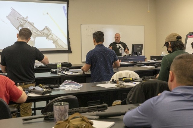 Keith Tyler, Sig Sauer instructor, provides instruction to students during the Armorer Sig Sauer MCX Rifle course at Armament University.