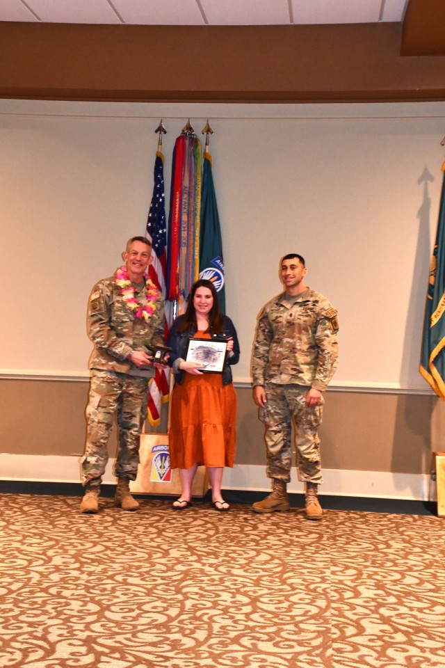 Marissa Schuhlein, was named Installation Volunteer of the Year stands with Brig. Gen. David Doyle, Joint Readiness Training Center and Fort Polk commanding general (left) and Command Sgt. Maj. Nema Mobarakzadeh, interim post command sergeant major (right).
