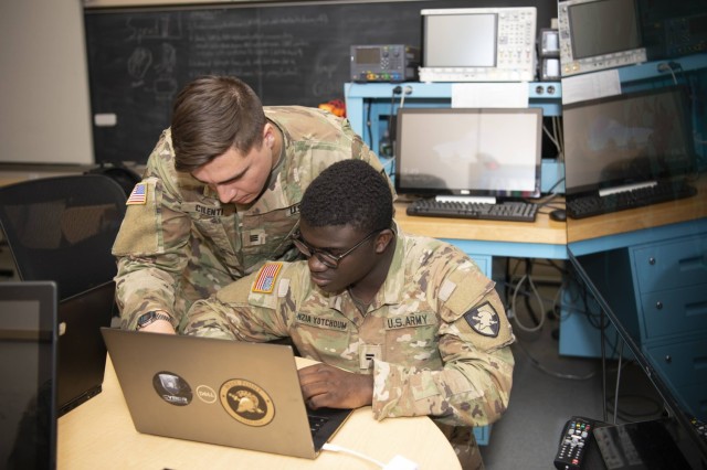 United States Military Academy Cadet Joseph Cilenti demonstrates to another cadet exactly how the Distributed Network Defense Solution enables network intrusion detection and prevention systems, all while keeping the network policed even when a monitor is not physically present.