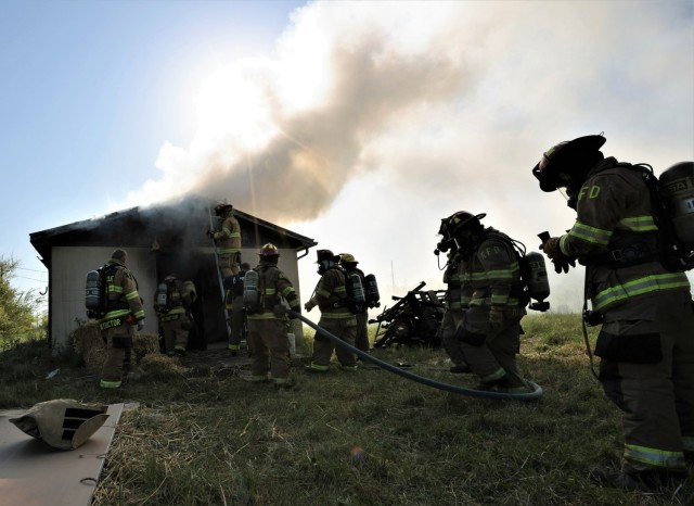 Six different area fire departments participate in the first “acquired structure burn” in nine years at Fort Knox April 27, 2022 as part of a multi-department training exercise.