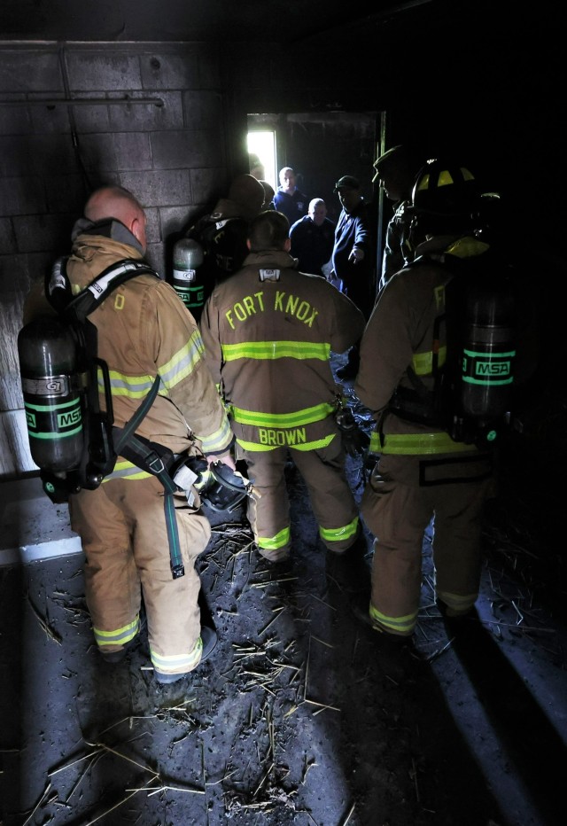 Firefighters from six different departments are briefed inside the structure where they will soon be battling flames as part of a multi-department training exercise April 27, 2022 at Fort Knox.