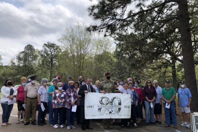Commanding General David S. Doyle and heritage families hold Fort Polk’s 80th Anniversary banner as they prepare to embark on cemetery tours at the Spring Heritage Tour, 27 March 2021. The installation mitigated for COVID-19 and partially repaired historic cemeteries from natural disaster damages to make them safe for the event. The installation hosts two heritage events per year, but due to COVID-19 restrictions, this was the first heritage event since the fall of 2019. 
