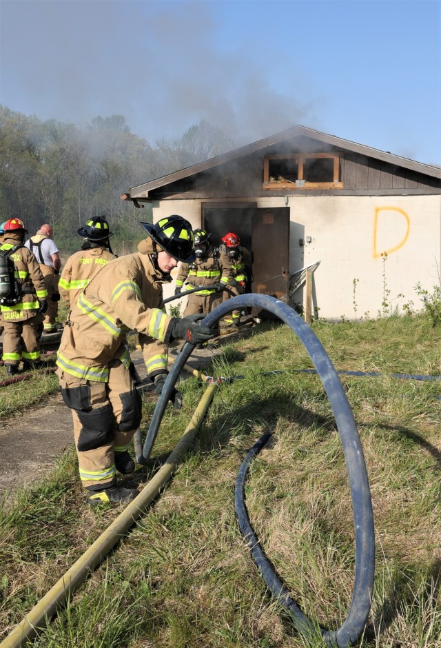 Firefighters from six different departments, as well as members of the Fort Knox Junior Firefighter Program work to extinguish flames April 27, 2022 as part of a multi-department training exercise.