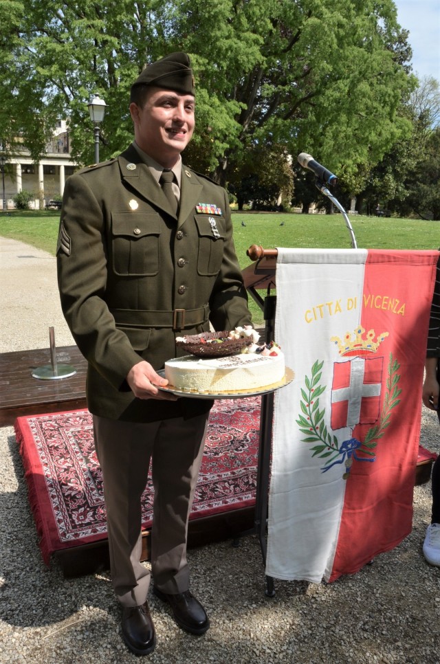 Soldiers from U.S. Army Garrison Italy return a birthday cake after 77 years