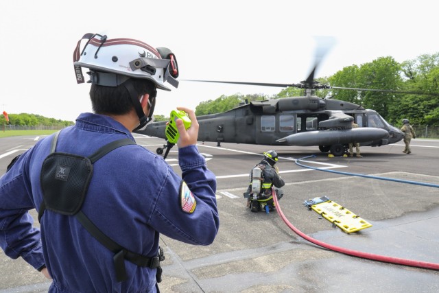 A training officer with the U.S. Army Garrison Japan Fire Department observes an emergency response to a mock aircraft crash at Kastner Airfield, Camp Zama, Japan, April 28, 2022.