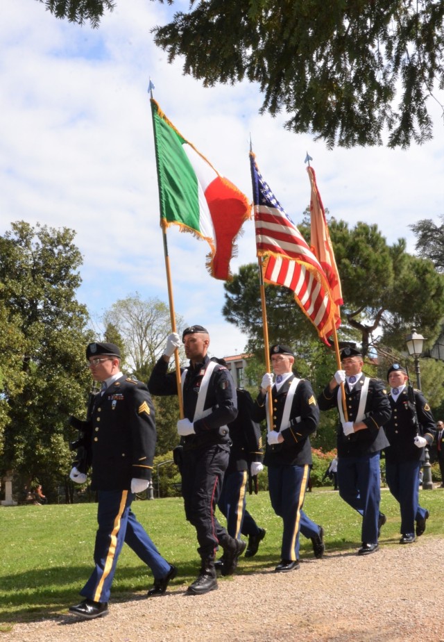 Soldiers from U.S. Army Garrison Italy return a birthday cake after 77 years