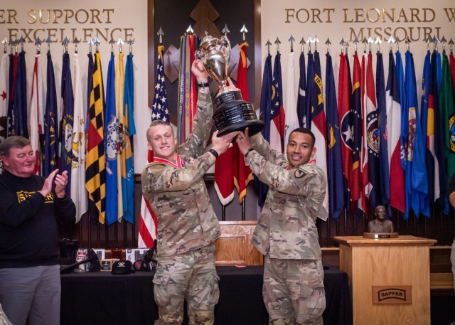Retired Lt. Gen. Robert Flowers, namesake of the competition, applauds as 1st Lt. Eric Mattia and Capt. Alaimoana Paunga, Team 17 with 20th Engineer Battalion out of Fort Hood, Texas, lift the trophy in celebration of winning the 15th annual Best Sapper Competition at Fort Leonard Wood, Missouri, during a ceremony held April 26 at Lincoln Hall Auditorium. 