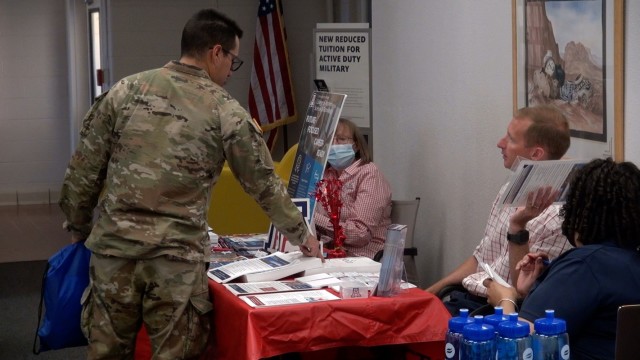 Prospective students browse booths and chat with school representatives at an education fair hosted by the Fort Huachuca Army Education Center. 